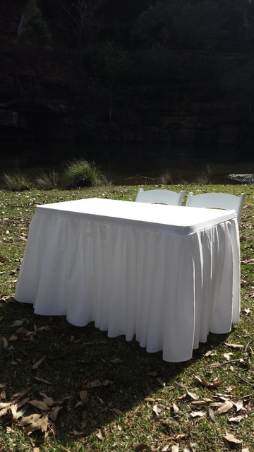 white skirted signing table